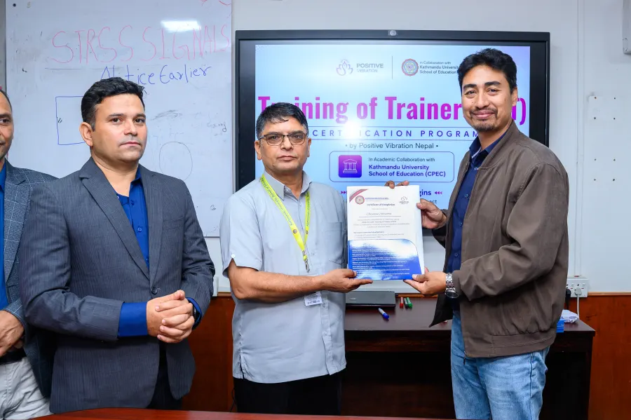 A KU-certified trainer with their certificate