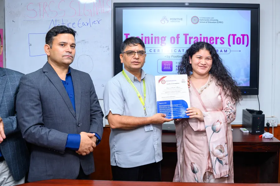 A KU-certified trainer with their certificate