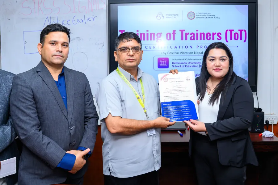 A KU-certified trainer with their certificate